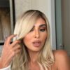 Beautiful girl wearing INDIA 22 inch HD transparent lace frontal wig with one hand on hair